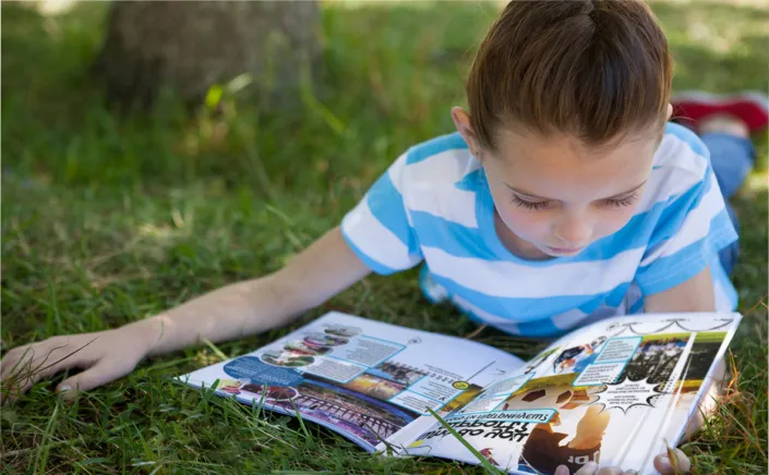 Girl reading Hello U book in park